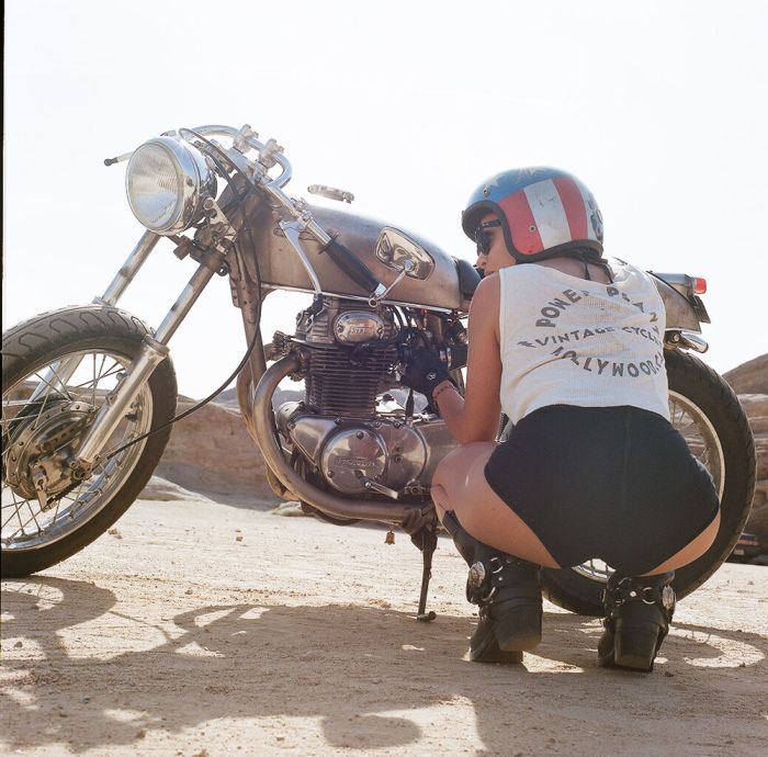 A playful frame from Girls on a motorcycle — online in Miami